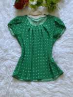 Blusa Plus Size Fernanda com estampa de bolinhas poá, fundo preto, mangas pétala, gola redonda. Confortável, clássica e versátil.