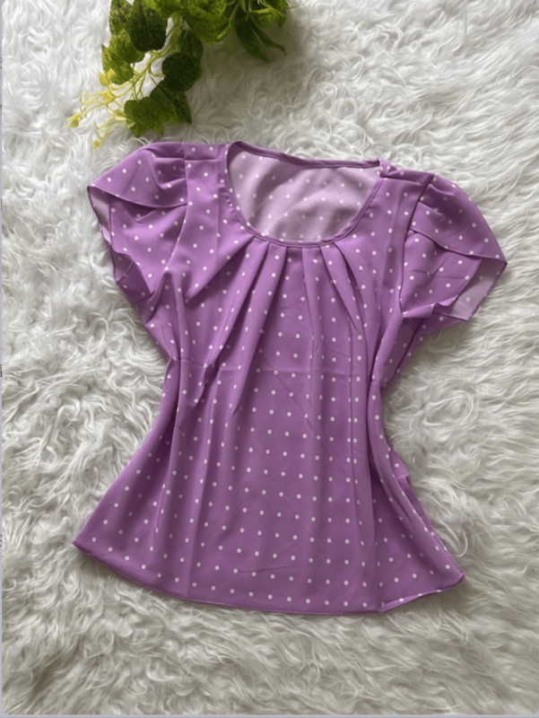 Blusa Plus Size Fernanda com estampa de bolinhas poá, fundo preto, mangas pétala, gola redonda. Confortável, clássica e versátil.