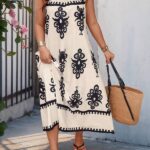 Vestido Bohemian Longo, estilo Boho, com estampa floral e tribal, alças finas e bainha flared. Confortável, ideal para dias ensolarados.