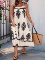 Vestido Bohemian Longo, estilo Boho, com estampa floral e tribal, alças finas e bainha flared. Confortável, ideal para dias ensolarados.