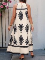Vestido Bohemian Longo, estilo Boho, com estampa floral e tribal, alças finas e bainha flared. Confortável, ideal para dias ensolarados.