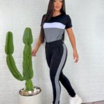 Conjunto feminino Ingrid com blusa listrada e calça com risca lateral, confeccionado em poliéster e elastano. Perfeito para um visual casual e moderno.