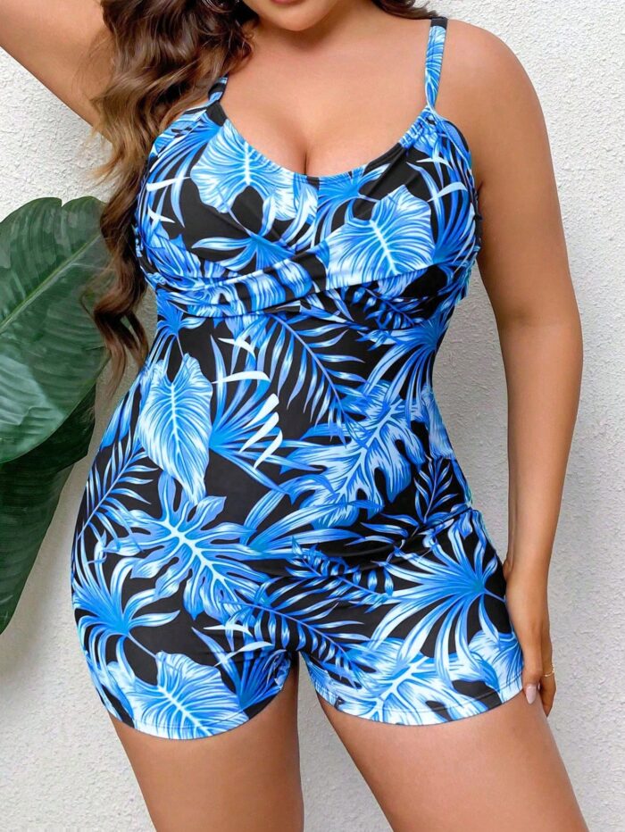 Maiô plus size com estampa tropical multicolorida, alças finas e ajuste confortável, ideal para férias na praia com estilo e confiança.