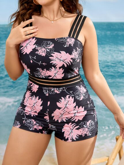 Maiô plus size com estampa floral multicolorida, alças grossas e malha de contraste, ideal para praia e piscina com conforto e estilo.