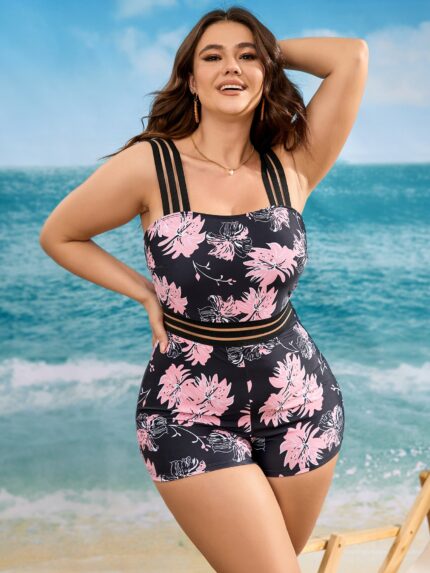 Maiô plus size com estampa floral multicolorida, alças grossas e malha de contraste, ideal para praia e piscina com conforto e estilo.