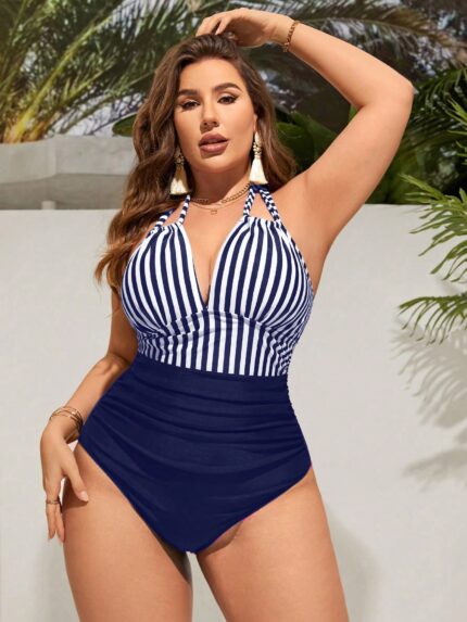 Maiô monokini plus size Vanessa, listrado azul marinho com decote V e costas nuas. Ideal para um visual descontraído e moderno na praia ou piscina.